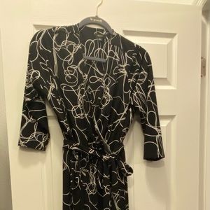 Black and white designed jumpsuit. Cross front with belt.